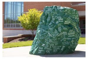 Ol' Spart, the large green rock, sits in the center of campus covered in handwritten names of YCP graduates from the most recent commencement.