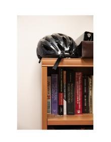 Ken's bike helmet on his bookshelf.