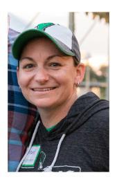 Rachel Finley, wearing a baseball cap, smiles in an outdoor photo.