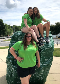 Gabrielle Ingoglia and two friends pose in front of the rock
