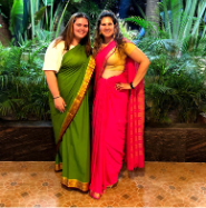 Gabrielle and her friend Sarah pose for a photo in India while wearing saris