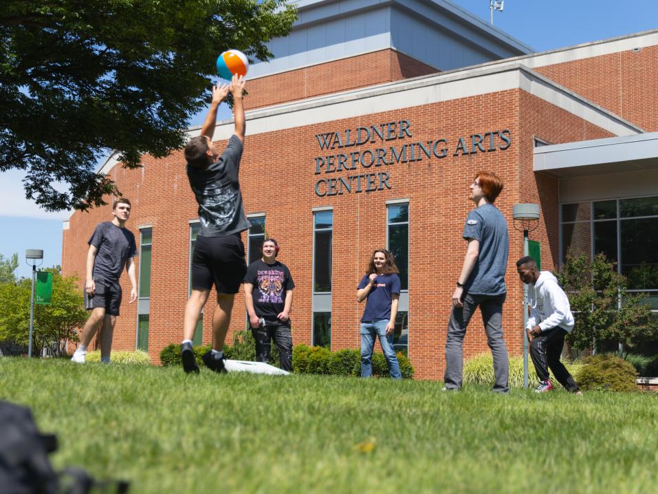 A group of students playing lawn games.