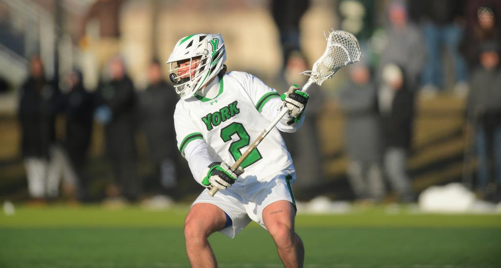 A lacrosse player wears his game day gear on field.