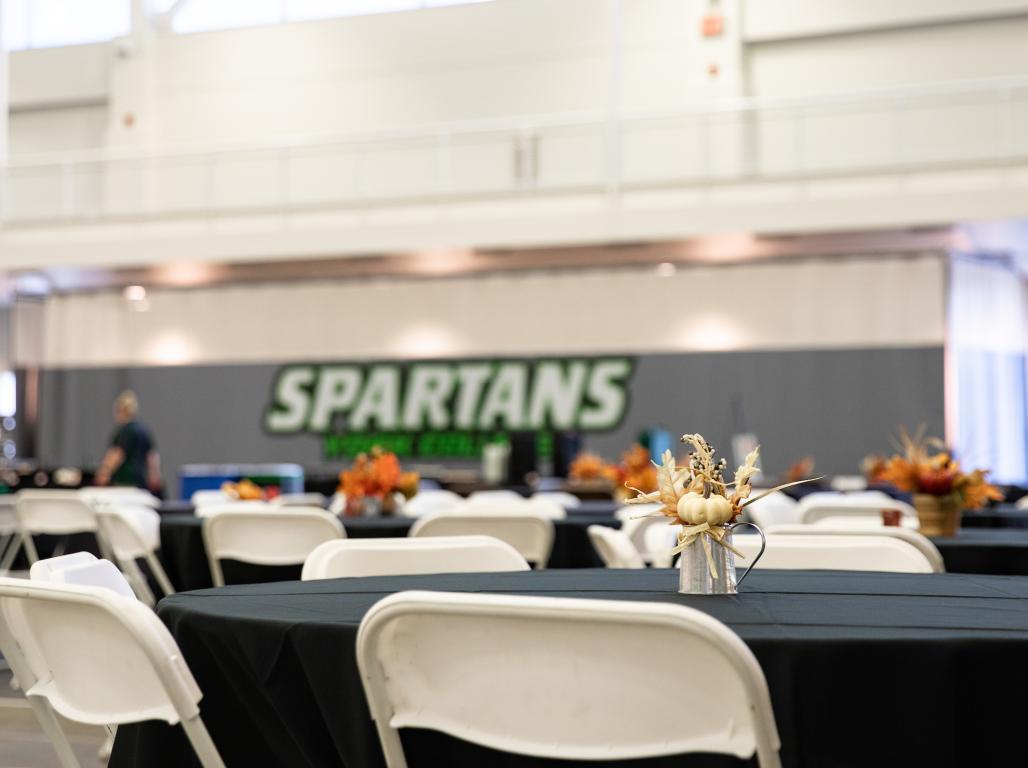 An empty table in the grumbacher center with fall decorations.