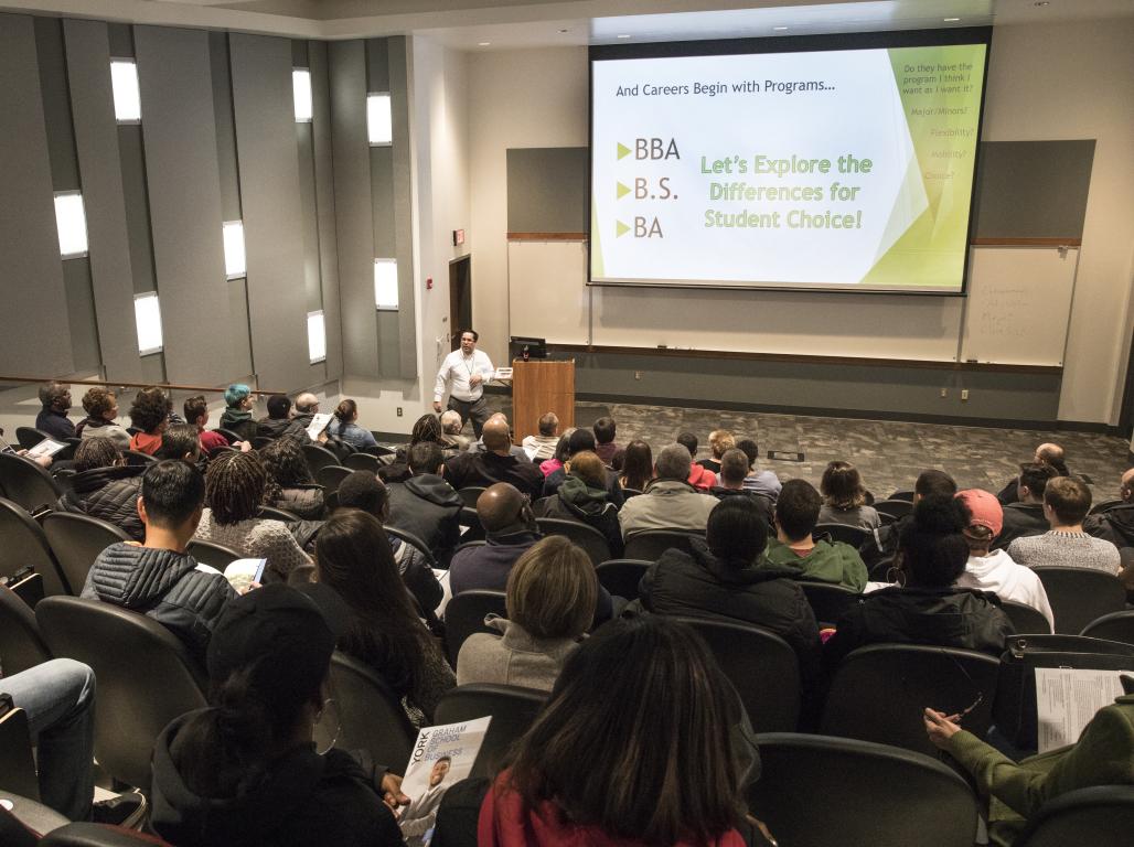 Prospective Student's Parents sit in on an informational presentation during an open house 