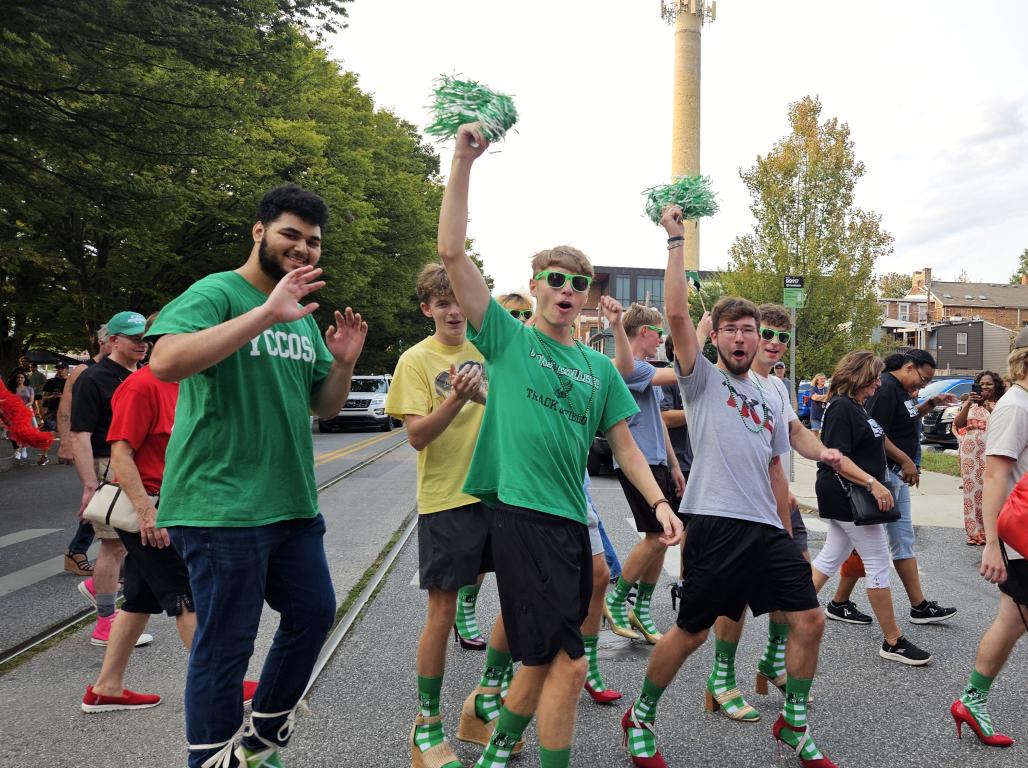 A group of YCP students in heels walking in downtown York city for the Walk a Mile in Her Shoes event
