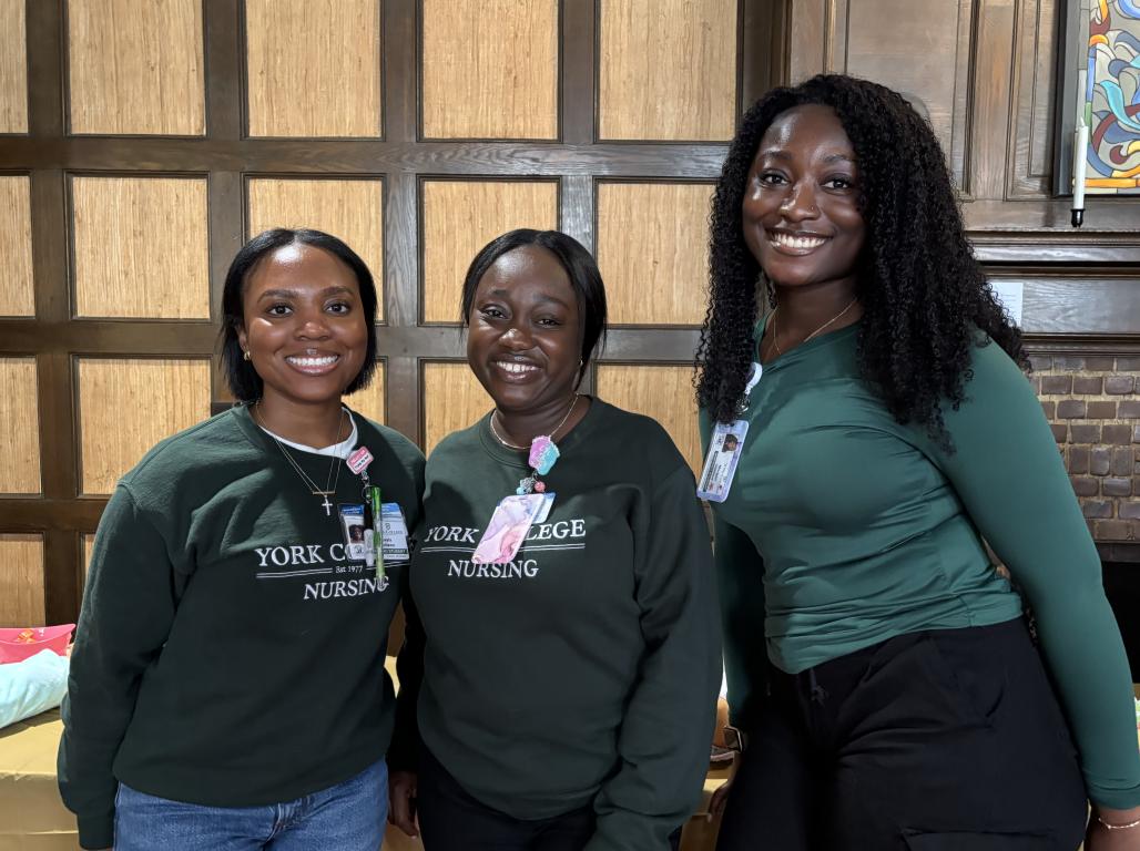 Three students pose for a photo wearing York College Nursing shirts.