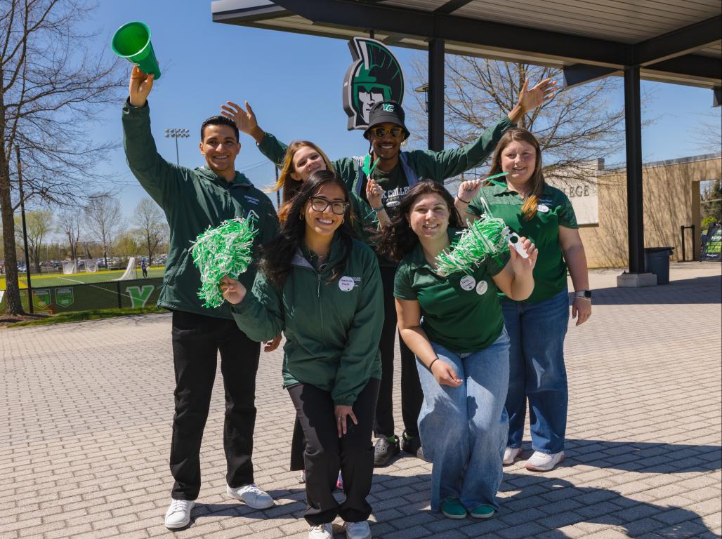 A group of York College students posing for a photo with props