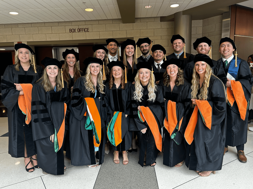Graduates in academic regalia pose together for a group photo at York College of Pennsylvania.