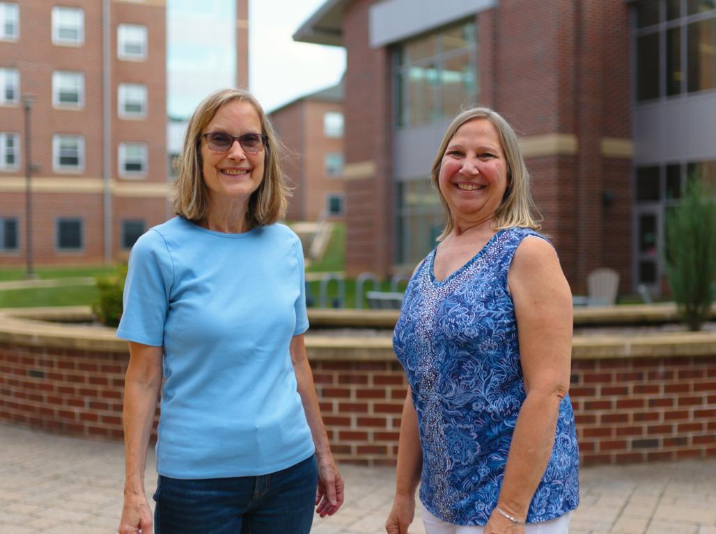 Two Lifelong Learning Initiative participants smile together outdoors on York College’s campus.
