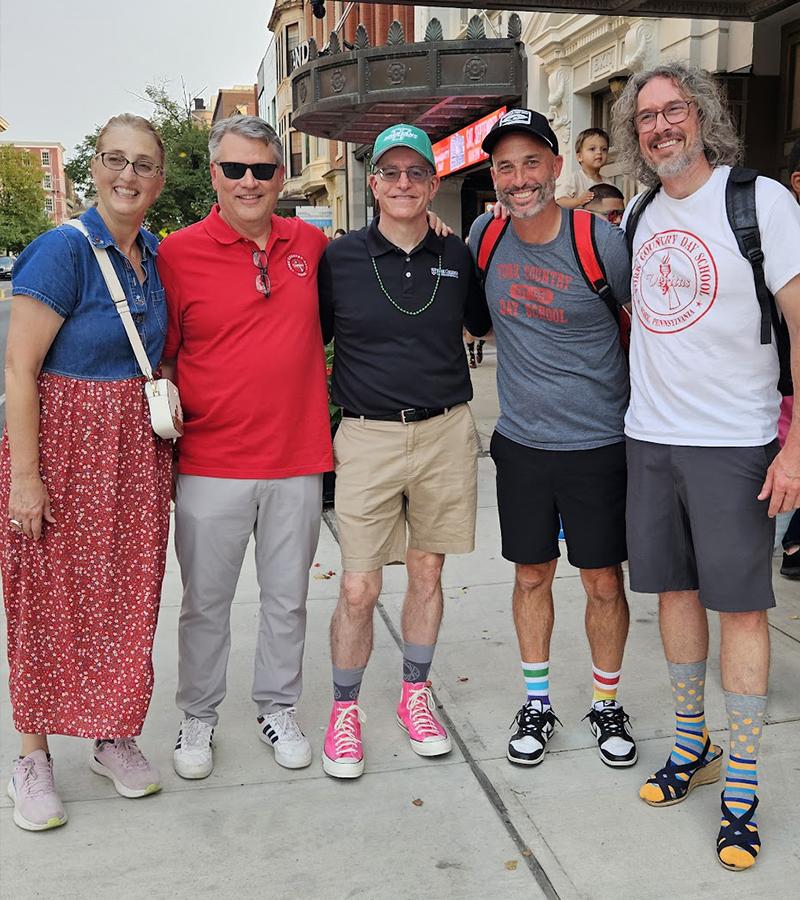 Dr. Burns poses for a photo for the Walk a Mile in Her shoes event with YCDS President Doug Key and others