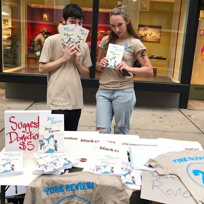 Two students holding copies of "The York Review."