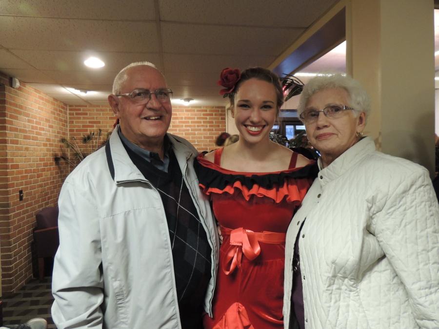 Stage actor posing with family after a show.