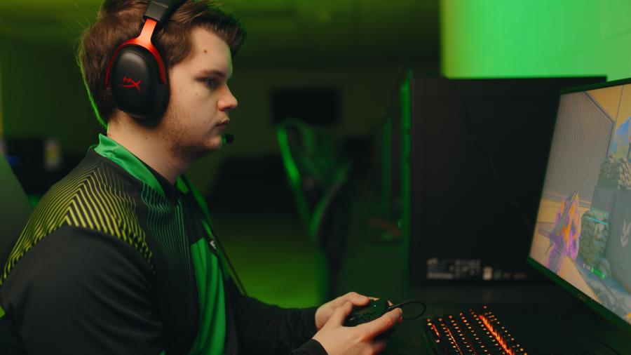 Person playing video games with headphones on. 