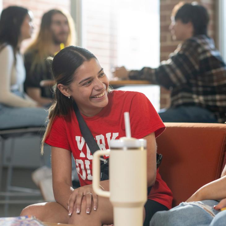 Student wearing a red shirt with white lettering that says "York College"