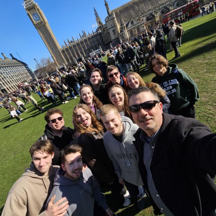 A group of students on a study abroad trip to London pose with Big Ben in the background